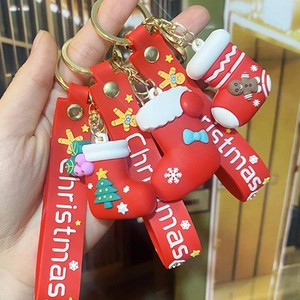 Close-up of 3D Christmas soft glue keychain with Santa sock and festive silicone strap