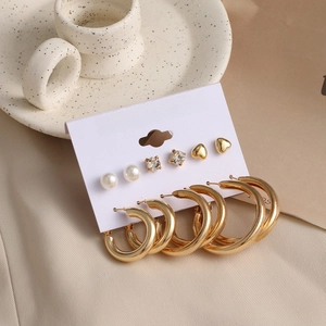 Detailed view of 6-pair gold earring set with pearls and rhinestones on fashion card