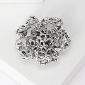 Elegant silver 3D rose flower brooch featuring hollow metal craft and secure pin clasp