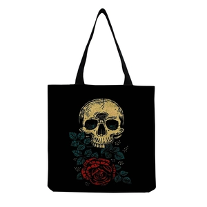 Close-up of black canvas tote bag featuring vintage skull and red roses graphic print