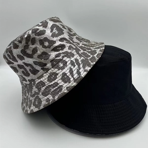 Detail shot of the silver leopard print and solid black bucket hats combination set