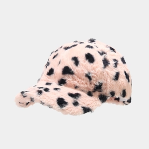 Detailed close-up of soft pink faux fur texture with black spotted pattern on a baseball cap