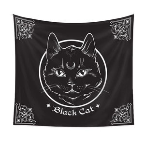 Detail of artistic black cat tapestry featuring crescent moon and line art motifs