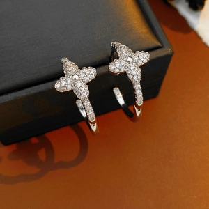 Macro detail of silver clover earrings with cubic zirconia stones on jewelry box