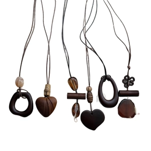 Retro geometric wood and resin pendant necklaces in various shapes on white background