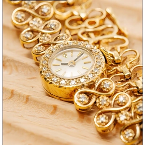 Luxury vintage gold women's watch with rhinestone bezel and ornate openwork strap
