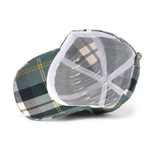 Macro view of plaid baseball cap interior with white sweatband and reinforced seams