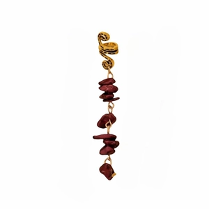 Detail of gold spiral hair cuff with hanging dark red natural stone pendants