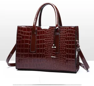 Detailed 45-degree side view of dark red crocodile pattern tote bag with silver hardware