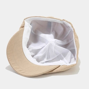 Inside view of beige cotton ivy cap showing premium lining and 100% cotton label
