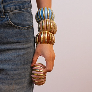 Detail of chunky resin and metal beaded bracelet showing colorful layered texture