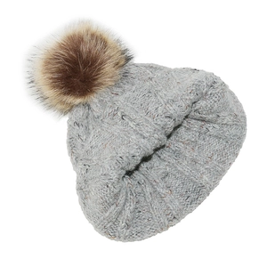 Detail of grey cable knit beanie showing thick wool texture and fluffy brown pompom