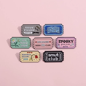 Set of 7 stamp-shaped Book Club enamel pins with literary genres on pink background