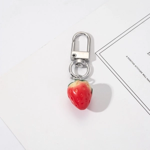 Detailed close-up of realistic resin strawberry keychain with silver metal buckle and ring