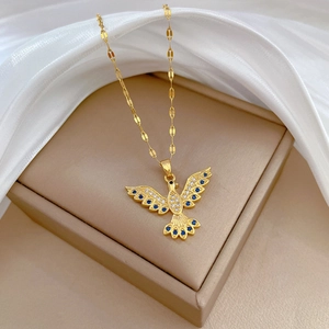 Elegant gold titanium phoenix necklace with blue and clear crystals on a silk backdrop