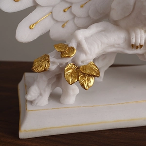 Elegant white peacock sculpture with gold leaf details and a rectangular base for home decor