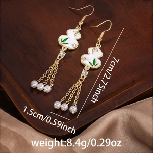 Detail of vintage bamboo tassel earrings with pearls and size measurements shown
