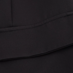 Close-up of black double-breasted blazer fabric texture with double stitching details