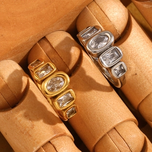 Macro shot of 18K gold and silver stainless steel rings with geometric zircon stones
