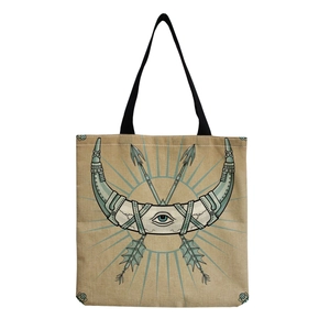 Detail of canvas tote bag featuring ethnic eye pattern print and black handles