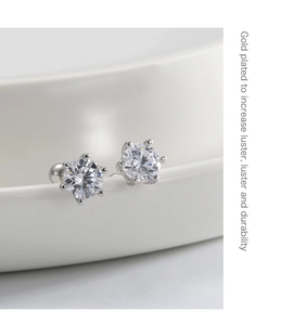 Macro shot of S925 sterling silver star stud earrings with round cubic zirconia and gold plating