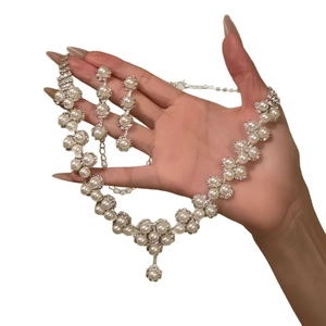Luxurious silver jewelry set with flower-shaped pearls and sparkling zircon accents