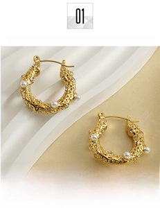 Detail of 18k gold plated C-shape earrings with lava texture, pearls and tiny zircons
