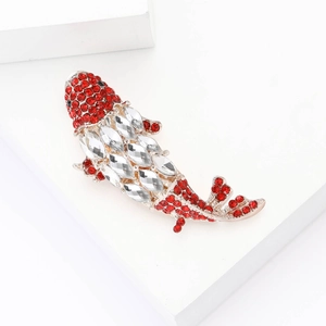 Elegant gold koi fish brooch with red and white rhinestones on a white geometric base