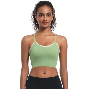 Detail of light green sports bra featuring thin straps and contrast trim for yoga wear