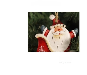 Detail of resin Santa Claus ornament hanging on a Christmas tree with jute rope