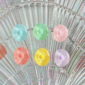 Colorful mini round resin charms in 6 vibrant colors on a holographic shell plate