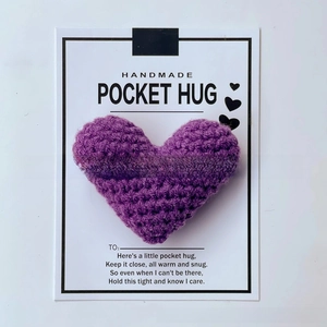 Close-up of handmade purple crocheted heart with Pocket Hug poem on a gift card
