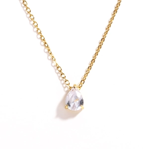 Detailed close-up of golden teardrop zircon pendant on a delicate chain necklace