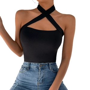 Women's black halter neck crossover ribbed knit top paired with blue jeans for a slim fit