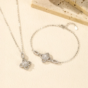 Luxurious S925 sterling silver four-leaf clover necklace and bracelet set on stone