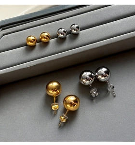 Polished silver and gold ball earrings shown in various sizes with silicone backings
