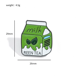 Detail view of green tea milk box enamel pin showing 29mm x 26mm size and 4.5g weight