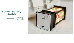 Detail view of the Christmas lantern base with battery compartment and power switch