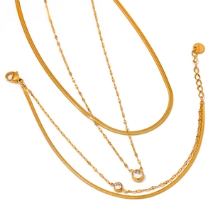 Detail of gold double-layer snake chain necklace with zircon pendant and S.Steel hallmark