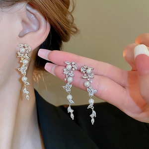 Detailed view of long pearl tassel earrings with marquise-cut cubic zirconia crystals