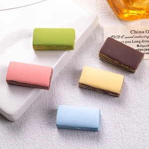 Macro view of five colorful resin layered cake charms for DIY crafts and jewelry making
