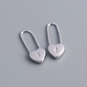 Macro view of S925 sterling silver heart lock earrings with clear hallmark engraving