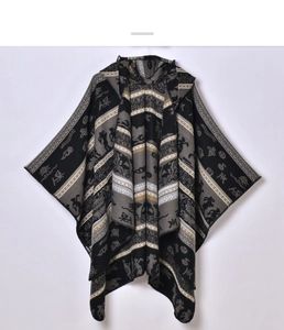 Detailed knit texture of ethnic hooded poncho featuring black grey patterns and gold stripes