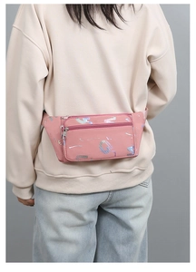 Rear view of model wearing pink holographic oxford waist bag with adjustable strap