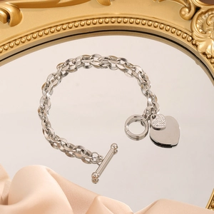 Polished stainless steel chain bracelet with double heart charms and toggle clasp