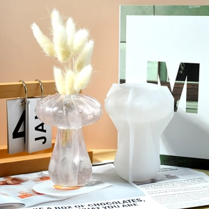 DIY mushroom silicone mold set with pink glitter resin flower vase on a wooden desk