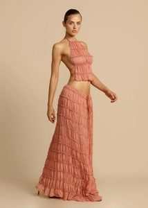 Detail of peach pink halter backless crop top and pleated maxi skirt set for women