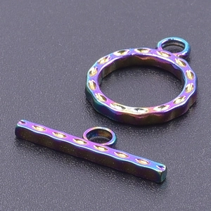 Macro shot of rainbow finish stainless steel OT toggle clasp with gold textured details