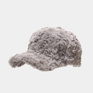 Close-up of thick dark gray plush faux fur texture on a warm winter baseball cap