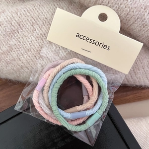 Colorful elastic fabric hair ties set in pastel pink blue and green with accessories card